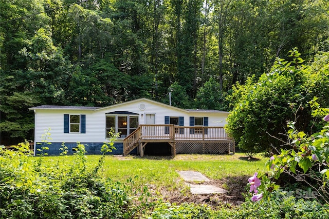 view of front facade featuring a deck and a front lawn