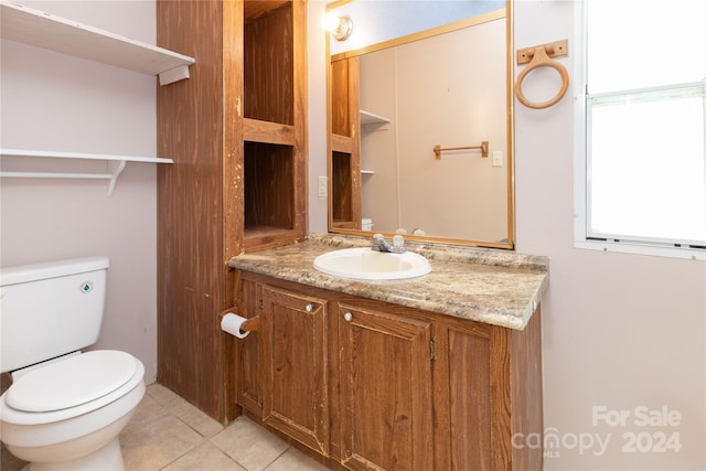 bathroom featuring tile patterned flooring, vanity, and toilet