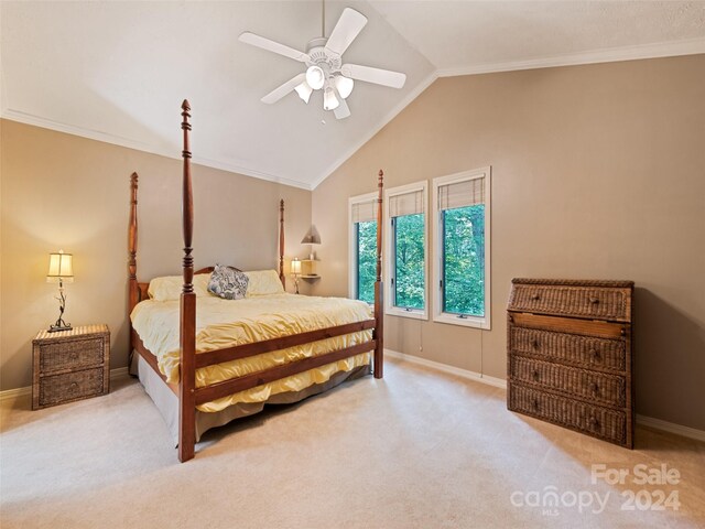 carpeted bedroom featuring vaulted ceiling, ceiling fan, and crown molding