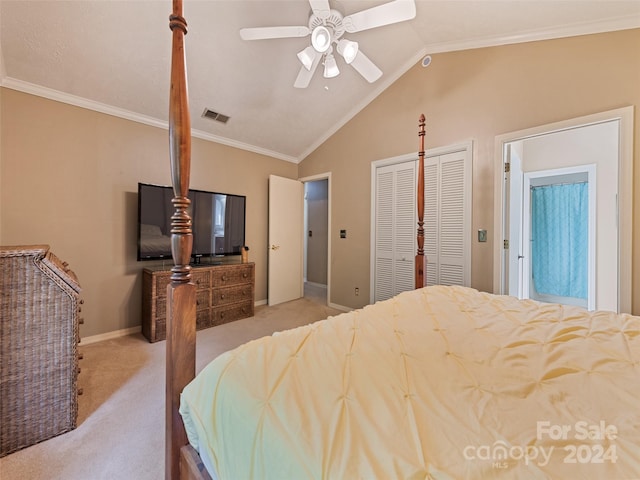 carpeted bedroom featuring a closet, vaulted ceiling, ceiling fan, and ornamental molding