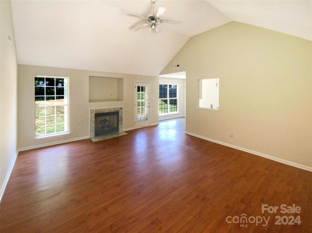 unfurnished living room featuring high vaulted ceiling, ceiling fan, a high end fireplace, and hardwood / wood-style flooring