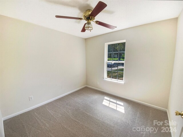 empty room with ceiling fan and carpet