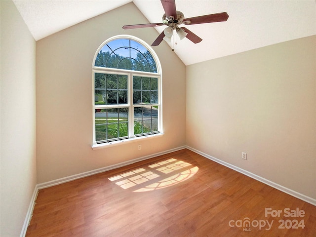 unfurnished room featuring ceiling fan, vaulted ceiling, and wood-type flooring