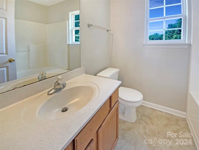 full bathroom with tile patterned flooring, shower / washtub combination, vanity, and toilet