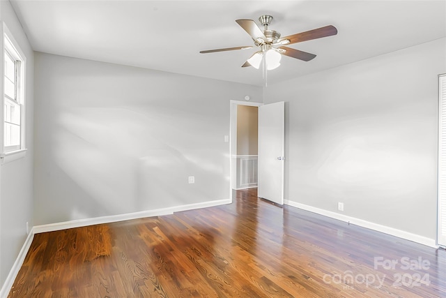 unfurnished room with ceiling fan and dark hardwood / wood-style floors