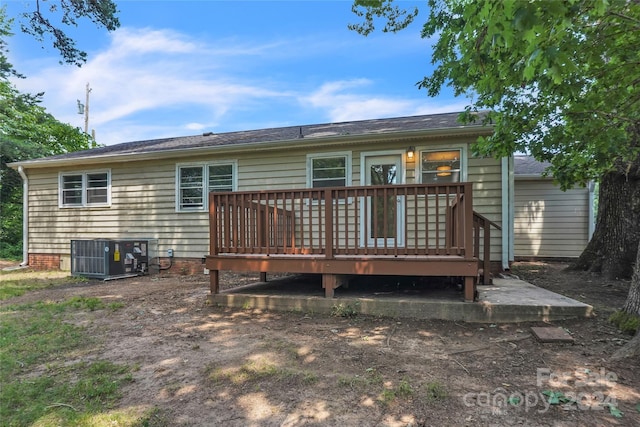 back of house featuring a wooden deck and central air condition unit