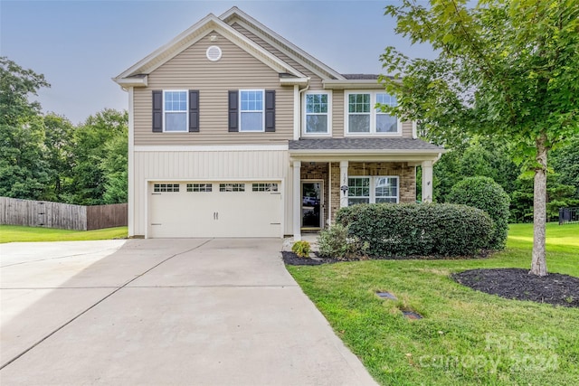 view of front of property featuring a garage and a front lawn