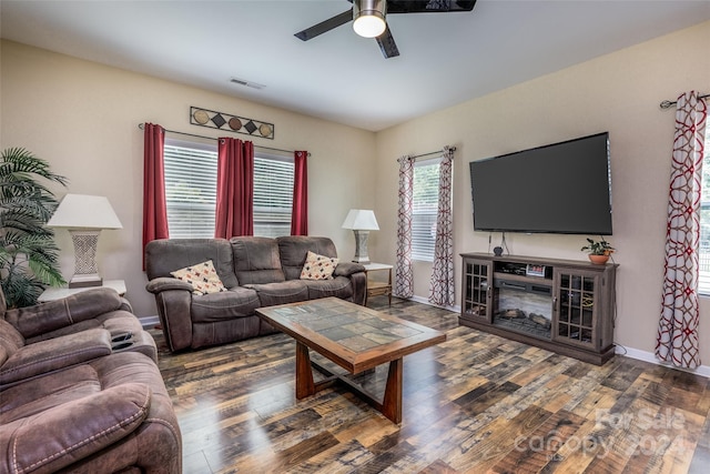 living room with ceiling fan and dark hardwood / wood-style flooring