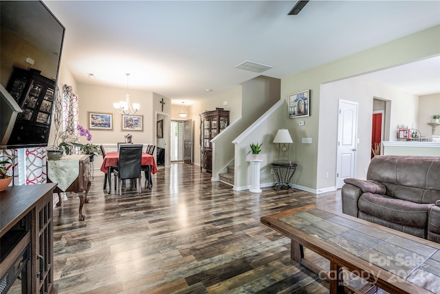 living room with a chandelier and dark hardwood / wood-style floors