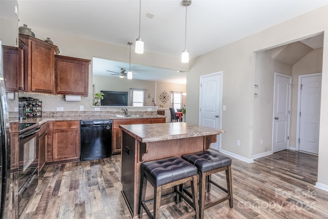 kitchen with dishwasher, hardwood / wood-style flooring, range, and a center island