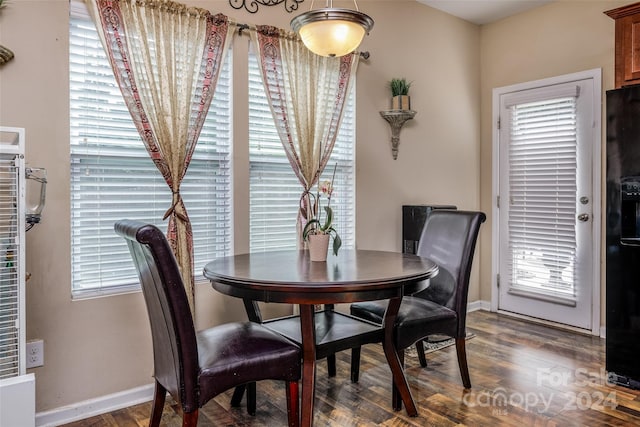 dining area with dark hardwood / wood-style flooring