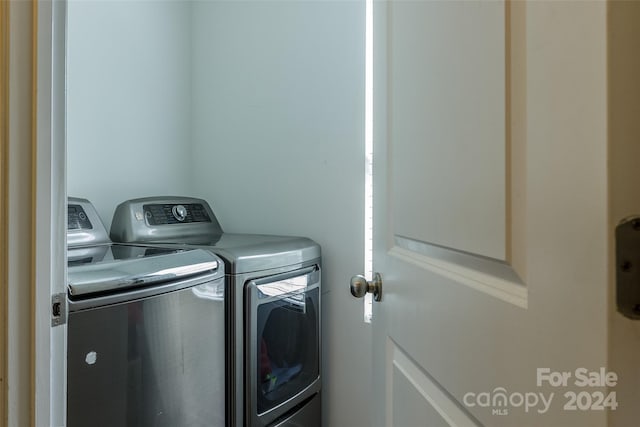 laundry room featuring washing machine and clothes dryer