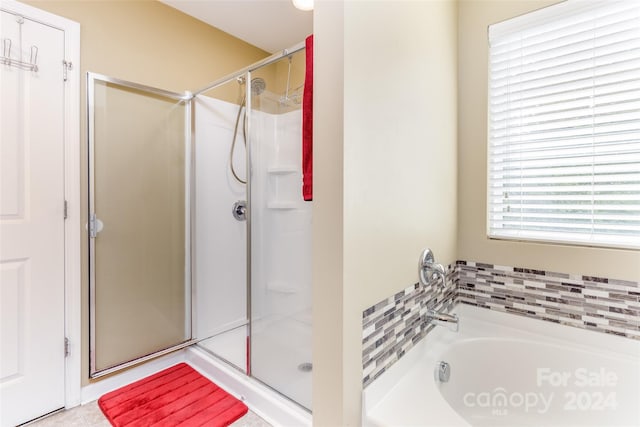 bathroom with shower with separate bathtub