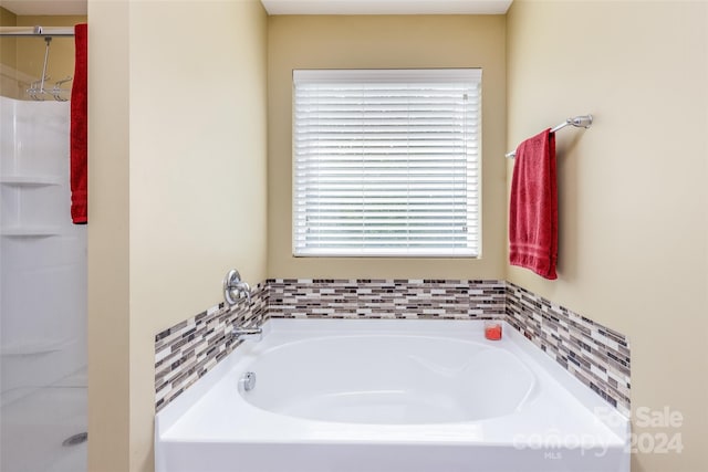 bathroom featuring shower with separate bathtub