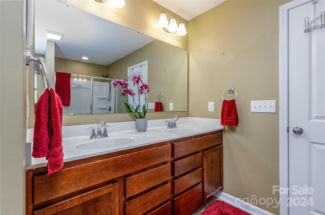 bathroom featuring vanity and a shower with door