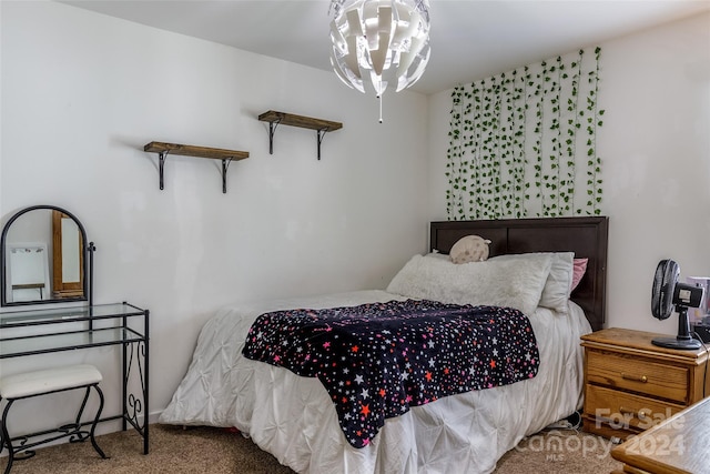 carpeted bedroom with an inviting chandelier