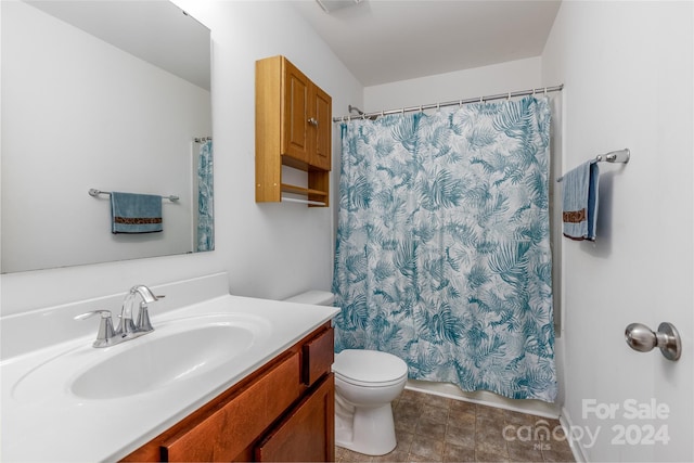 bathroom with toilet, vanity, and a shower with shower curtain