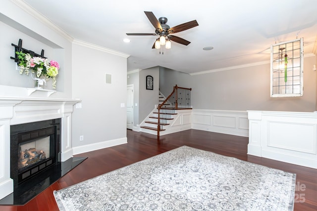 living room with ceiling fan, ornamental molding, and dark wood-type flooring