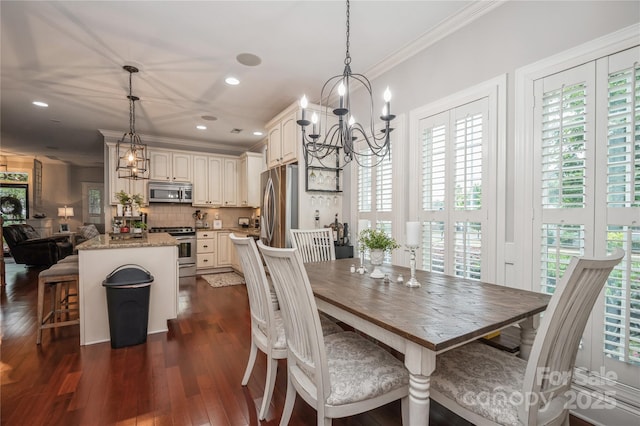 dining space featuring dark hardwood / wood-style flooring, an inviting chandelier, and crown molding