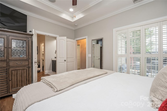 bedroom featuring ensuite bathroom, ceiling fan, dark hardwood / wood-style flooring, and crown molding