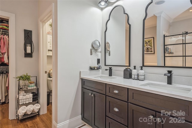 bathroom with hardwood / wood-style floors, vanity, and toilet