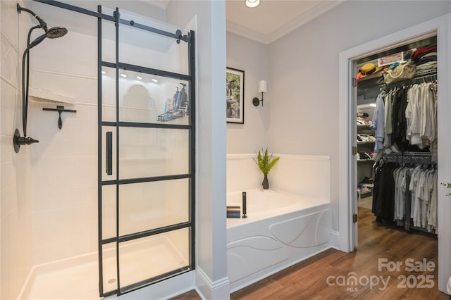 bathroom with crown molding, hardwood / wood-style floors, and independent shower and bath