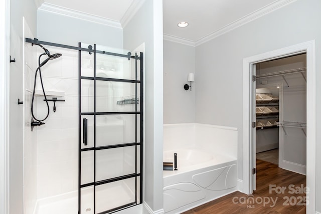 bathroom with ornamental molding, hardwood / wood-style flooring, and independent shower and bath