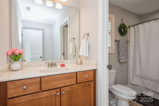 bathroom with a shower with curtain, vanity, and toilet