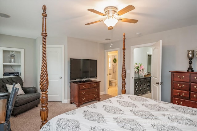 bedroom with connected bathroom, light colored carpet, and ceiling fan