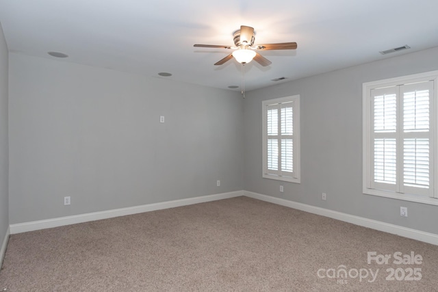 carpeted empty room featuring ceiling fan