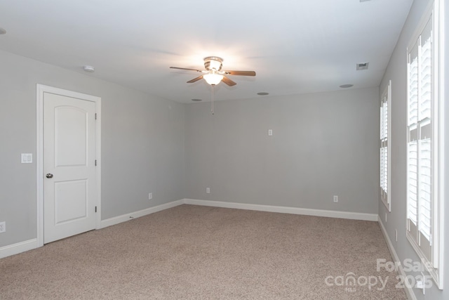 unfurnished room with carpet and ceiling fan