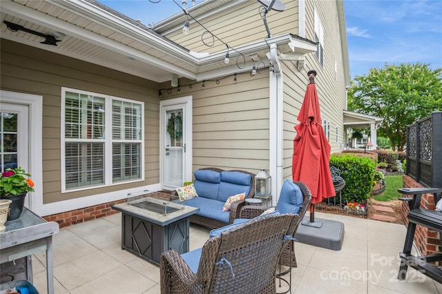 view of patio featuring an outdoor living space with a fire pit