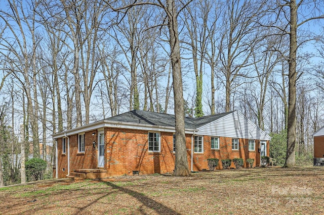 view of home's exterior featuring brick siding and crawl space