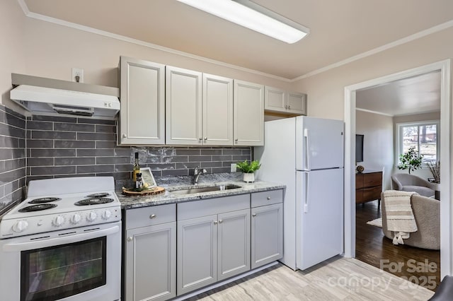 kitchen featuring white appliances, ornamental molding, ventilation hood, gray cabinetry, and a sink