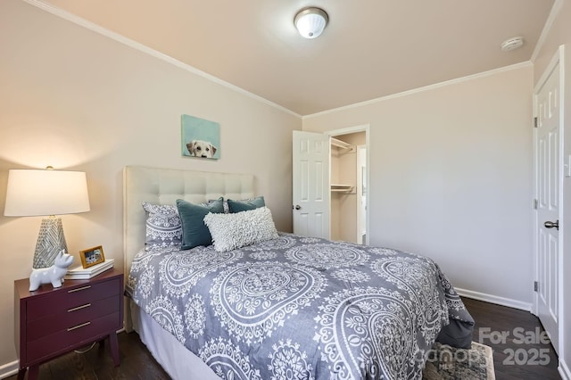 bedroom with dark wood-style flooring, crown molding, and baseboards