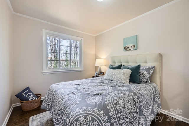 bedroom with crown molding, baseboards, and wood finished floors