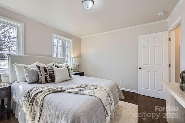 bedroom with ornamental molding, dark wood finished floors, and baseboards