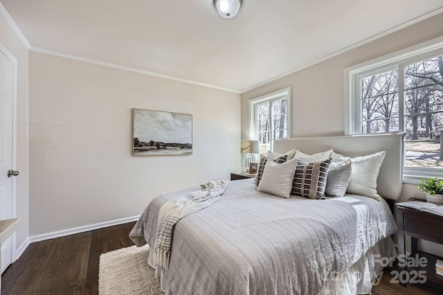 bedroom featuring baseboards, dark wood-style flooring, and crown molding