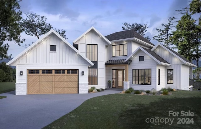 modern inspired farmhouse featuring a garage and a front lawn