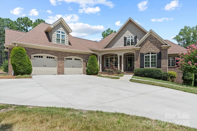 view of front of home with concrete driveway, brick siding, and an attached garage