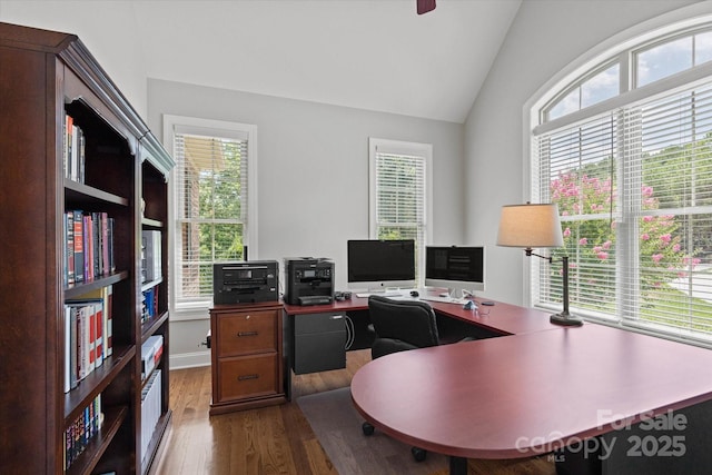 office space with vaulted ceiling and dark wood finished floors