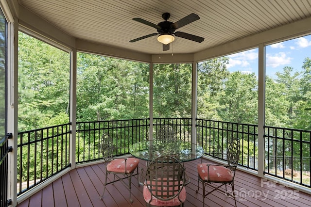 wooden deck with a ceiling fan and outdoor dining space