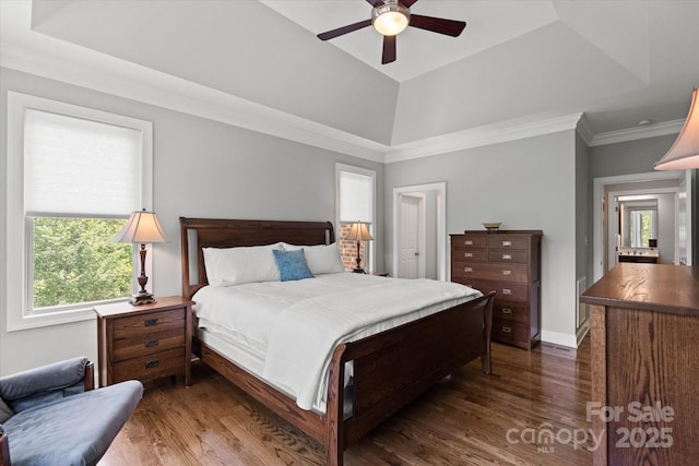 bedroom with dark wood-type flooring, a raised ceiling, and ornamental molding