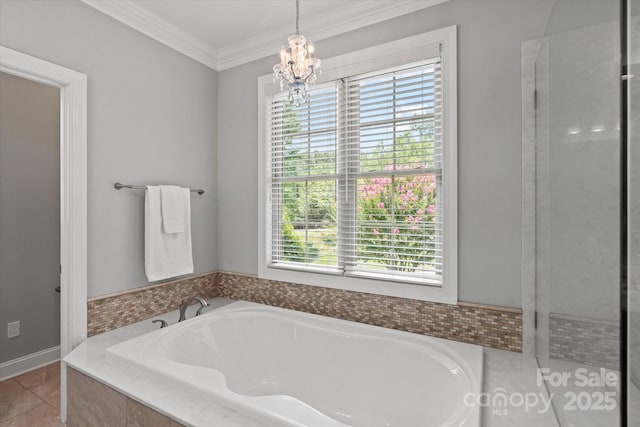 bathroom featuring a chandelier, ornamental molding, tile patterned flooring, and a garden tub