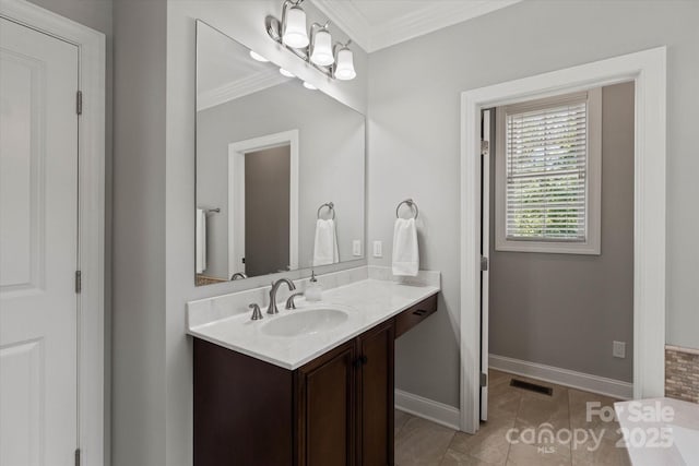 bathroom with visible vents, baseboards, ornamental molding, tile patterned flooring, and vanity