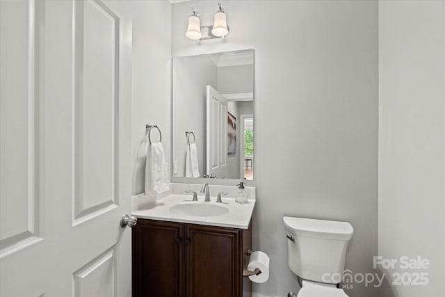 half bath with vanity and toilet