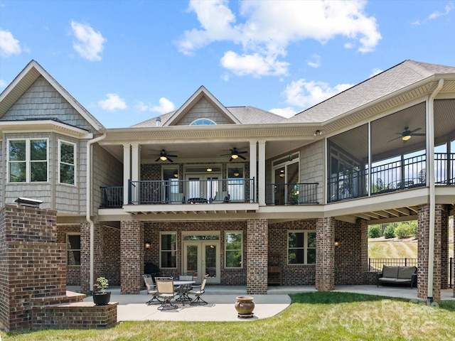 rear view of property with brick siding, a patio area, and a ceiling fan