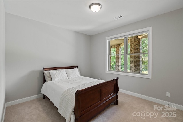 bedroom with carpet floors, visible vents, and baseboards