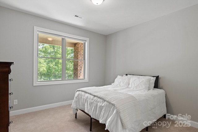 carpeted bedroom featuring visible vents and baseboards