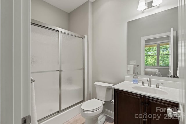 bathroom with toilet, ensuite bath, vanity, and a shower stall